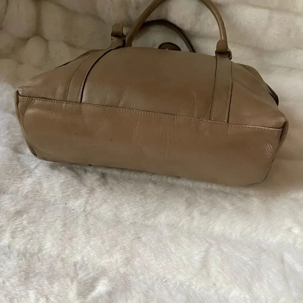 Tano Leather tan frame medium satchel gold tone hardwares .